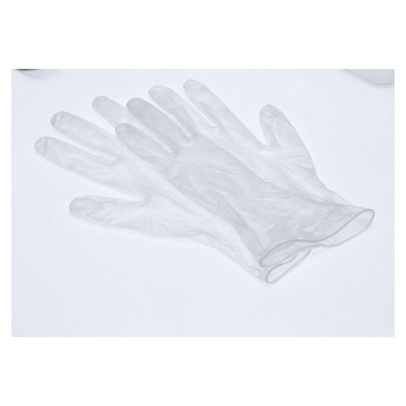 Par de guantes de vinilo transparentes sobre una mesa blanca